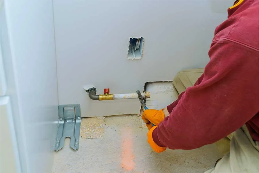 Plumber replacing damaged gas pipe