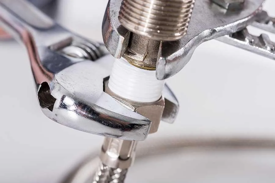 Plumber performing routine maintenance